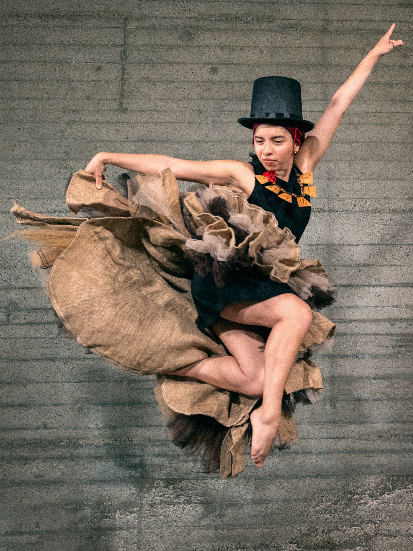 Jess DeFranco performing — mid-air leap in costume